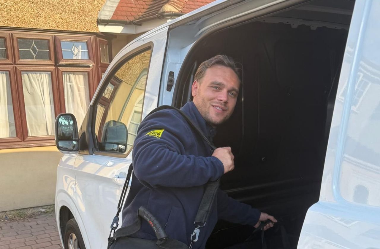 Platinum Gas Solutions engineer in Gas Safe branded uniform at his work van in south London