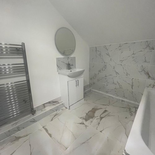 Finished bathroom with heated towel rail and vanity unit plumbed in